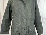 the jacket is green and has a brown collar on it