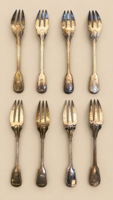a lot of forks and spoons that are on the table