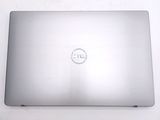dell laptop computer sitting on top of a white table with a logo on the screen