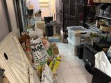 a room with a refrigerator and many boxes in it