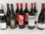 several bottles of wine are lined up in a row on a white surface