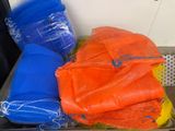 many bags of orange, blue and yellow items in a bin
