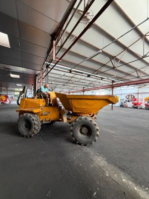 a large yellow dump truck parked in a parking lot