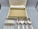 a box with silverware in it on a table