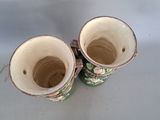 two vases that are sitting on a table