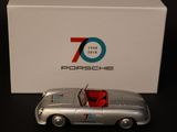 an image of a silver toy car sitting next to a white box