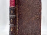 an old book sitting on top of a table next to a white background