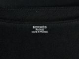 a close up of a black t shirt with a white logo on the chest