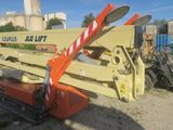 a crane that is sitting on the ground in the dirt