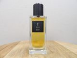 an image of a bottle of perfume sitting on top of a wooden table