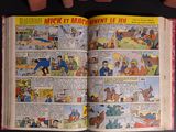 a comic book open on a black table