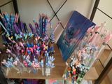 a lot of pens and pencils on the table