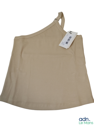 a tan top with a tag on it on a white background