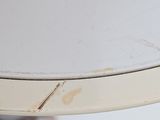 a close up of a white table with a brown spot on the top