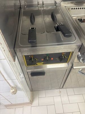 a picture of a commercial kitchen with two deep fryers