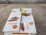 several boxes of fruit sit on a pallet in front of a building