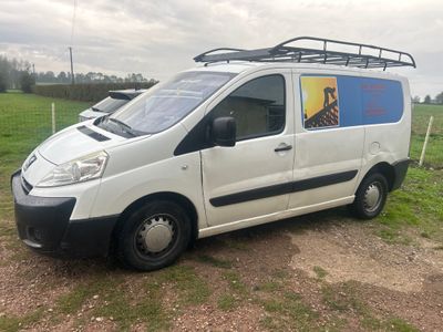 a white van that is parked on the side of the road