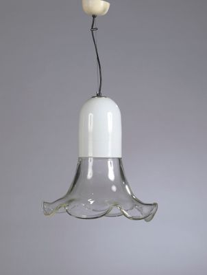 an image of a glass hanging light with a bird on top of it