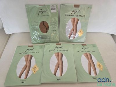 four pairs of footless stockings sitting on top of a bed