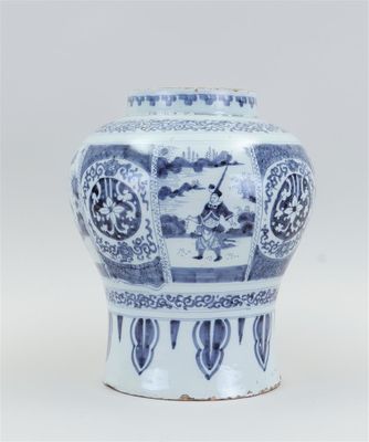 a blue and white vase sitting on a table