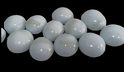 a pile of white eggs on a black background