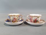 two cups and saucers are sitting on a table
