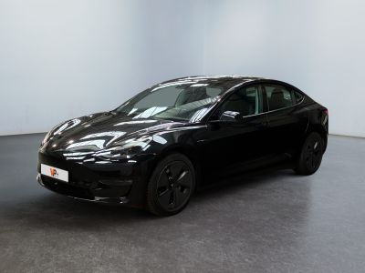 black tesla model s parked in a white room with a black floor