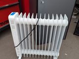 a white radiator sitting on the floor next to a red cabinet