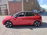 a picture of a red car parked in front of a building