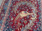 an image of a red rug with a bird design on it