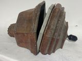 an old rusted metal object on a white surface