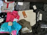 a lot of clothes that are sitting on a couch