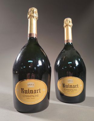 two bottles of champagne sitting next to each other on a table
