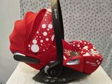 the baby car seat is red and white with polka dots on it