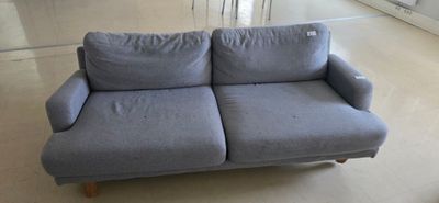 a blue couch that is sitting in a room