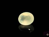 a close up of a white ball on a black surface
