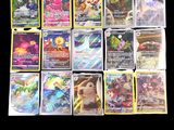 a lot of pokemon cards on a black background