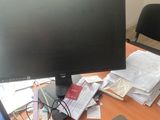 a computer monitor sitting on a desk next to a laptop computer