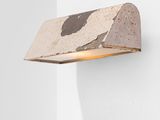 a close up of a light on a wall near a white wall
