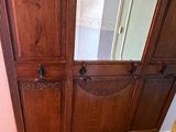 a wooden cabinet with a mirror on top of it