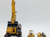 two toy construction vehicles that are sitting next to each other