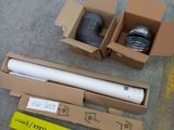 a box with a roll of paper and a roll of tape on the floor