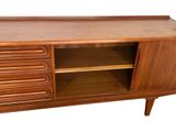 an image of a wooden cabinet with drawers and shelves