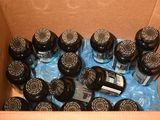 a cardboard box filled with bottles of water and a cell phone