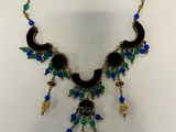 a black and blue necklace on a white background