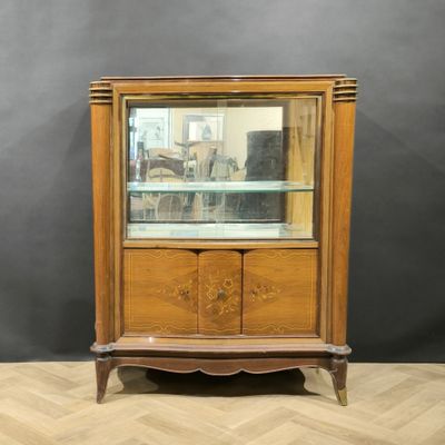 a wooden display cabinet with glass shelves and drawers