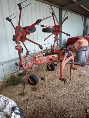 un tracteur rouge garé dans une grange