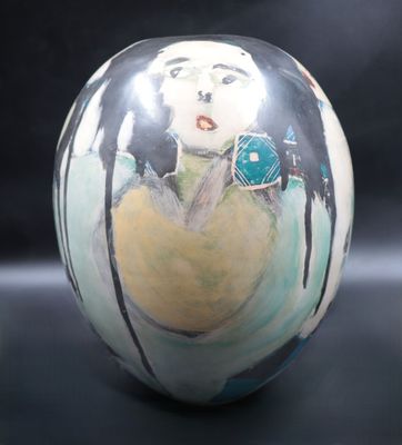 a vase that has a picture of a woman on it
