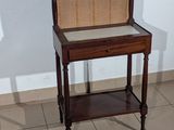 a small table with a chair on it in a room