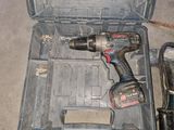 a cordless drill in a tool box with a cord